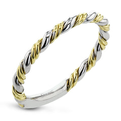 This ring is a twist on a halo engagement ring, with 18k yellow and white gold intertwining in the band.