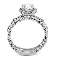 This ring is a twist on a halo engagement ring, with 18k yellow and white gold intertwining in the band.