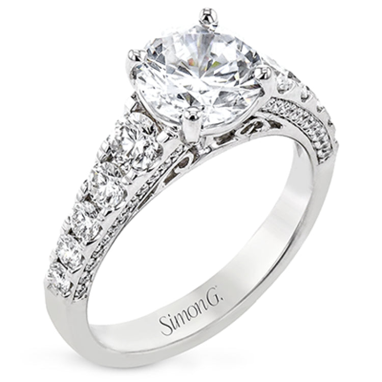 Filigree details underneath the center stone and diamonds that extend down the sides of this ring make it far from ordinary.