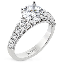 Filigree details underneath the center stone and diamonds that extend down the sides of this ring make it far from ordinary.