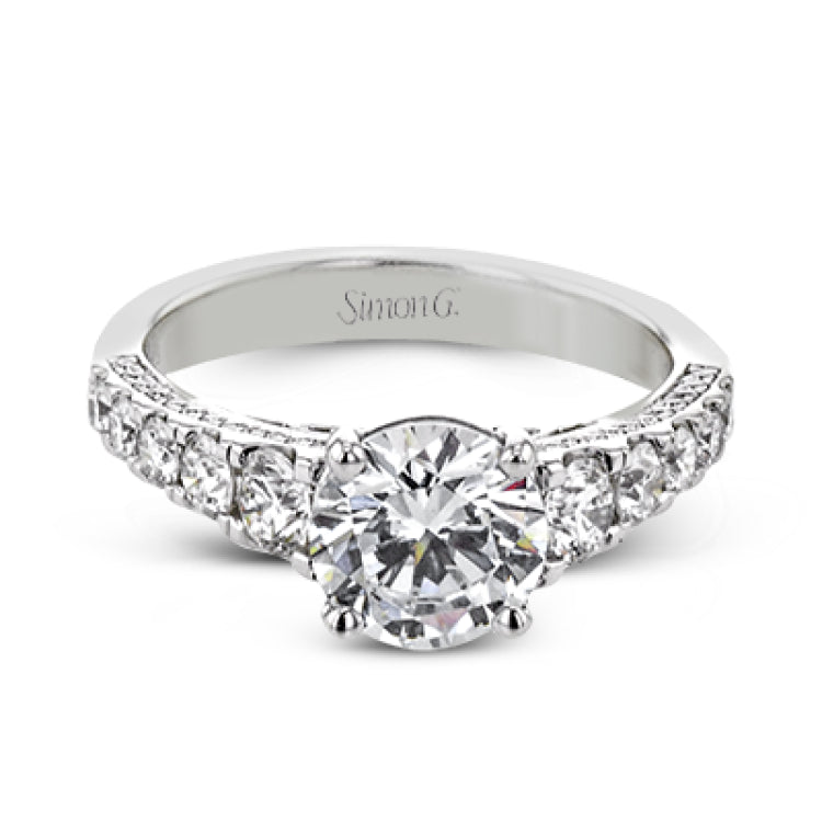 Filigree details underneath the center stone and diamonds that extend down the sides of this ring make it far from ordinary.