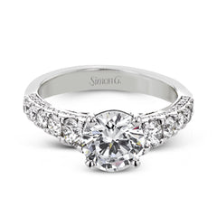 Filigree details underneath the center stone and diamonds that extend down the sides of this ring make it far from ordinary.