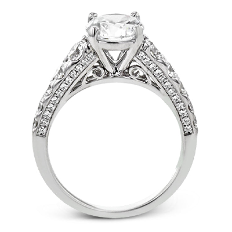 Filigree details underneath the center stone and diamonds that extend down the sides of this ring make it far from ordinary.