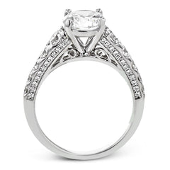 Filigree details underneath the center stone and diamonds that extend down the sides of this ring make it far from ordinary.