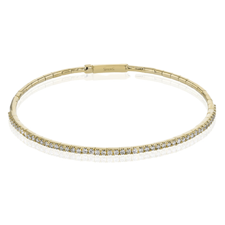 This 18K yellow gold bangle bracelet featuring .76ctw diamonds is perfect for everyday wear or a night out on the town. This wardrobe staple pairs perfectly with any jewelry collection.