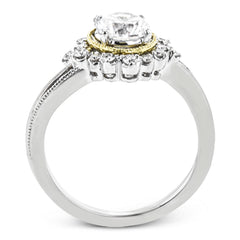 Full of interesting design details, this engagement ring from our Supernova collection features a yellow gold milgrain halo around the center stone, and an outer halo set with .20 ctw of white diamonds.