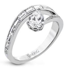 Like lightning zig-zagging across the sky, this dynamic 18k white gold ring contains a flowing line of .62 ctw baguette diamonds and one .55 ct pear shaped diamond set at an angle.