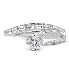 Like lightning zig-zagging across the sky, this dynamic 18k white gold ring contains a flowing line of .62 ctw baguette diamonds and one .55 ct pear shaped diamond set at an angle.