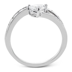 Like lightning zig-zagging across the sky, this dynamic 18k white gold ring contains a flowing line of .62 ctw baguette diamonds and one .55 ct pear shaped diamond set at an angle.