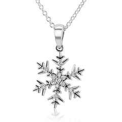 Outshine the brightest winter snow in this sparkling snowflake pendant crafted from 18k white gold and set with .07 ctw of white diamonds.