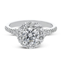 This lovely engagement ring provides an impressive amount of sparkle with .73 ctw in a halo design.