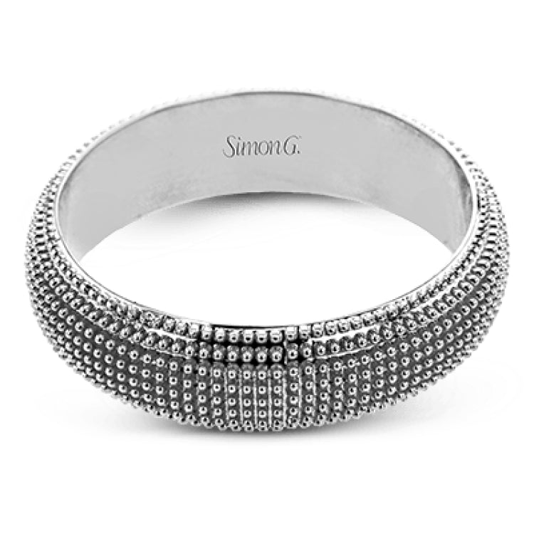 This 14k gold band features a granulated surface that is hand-created by experienced artisans.