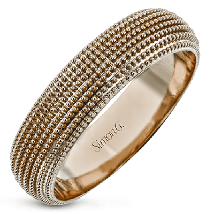 This 14k gold band features a granulated surface that is hand-created by experienced artisans.