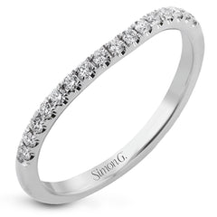 This criss-cross design engagement ring shimmers with 0.15 ctw round diamonds and a halo of gold strands wrapped around the center