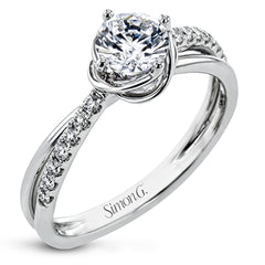 This criss-cross design engagement ring shimmers with 0.15 ctw round diamonds and a halo of gold strands wrapped around the center