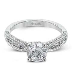 Delightful details abound in this 18k white gold engagement ring, set with .33 ctw of side diamonds.