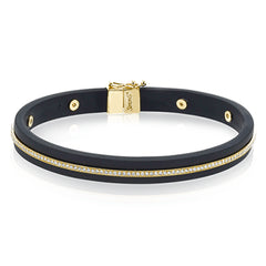 A sleek line of .39 ctw of diamonds makes a statement in this black rubber bracelet with 14k gold elements.