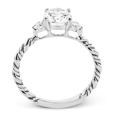 Wrap this ring around your finger for a distinctive style statement sure to stand the test of time- yellow and white 18k gold twisted together with .24 ctw of white diamond side stones.