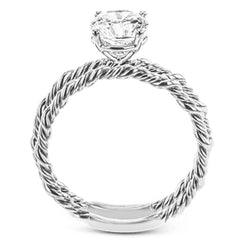 Two tones of 18k gold twist around each other in this contemporary yet timeless engagement ring.