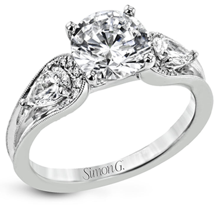 This modern 3 stone engagement ring takes a Round center and is flanked by 2 pear shaped diamonds 0.36 ctw., and 0.06 ctw of round diamonds