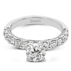 This engagement ring is stunning from every side, with .97 ctw of white round diamonds on the top and sides of the ring.