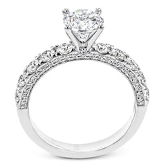 This engagement ring is stunning from every side, with .97 ctw of white round diamonds on the top and sides of the ring.