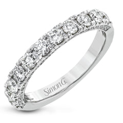 This engagement ring is stunning from every side, with .97 ctw of white round diamonds on the top and sides of the ring.