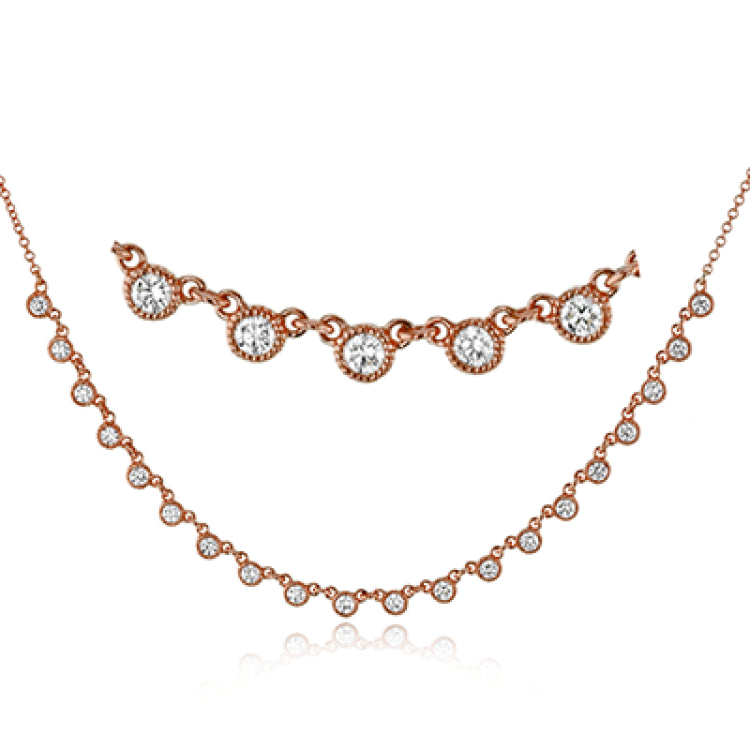 A line of .61 ctw bezel set diamonds lay gracefully across the clavicle in this 18k yellow gold necklace that is perfect for layering.
