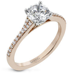 Simple yet stunning, this graceful engagement ring is made for a round cut center stone and is set with .16 ctw of white diamonds.