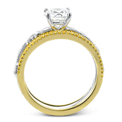 This beautiful two-tone 18k gold wedding set features an organic design white gold inner ring, with a yellow gold jacket surrounding it that is set with .22 ctw of yellow diamonds.