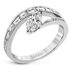 Baguette diamonds and milgrain details in white gold enhance the marquise center stone set at an angle in this dynamic Lightning Collection ring.