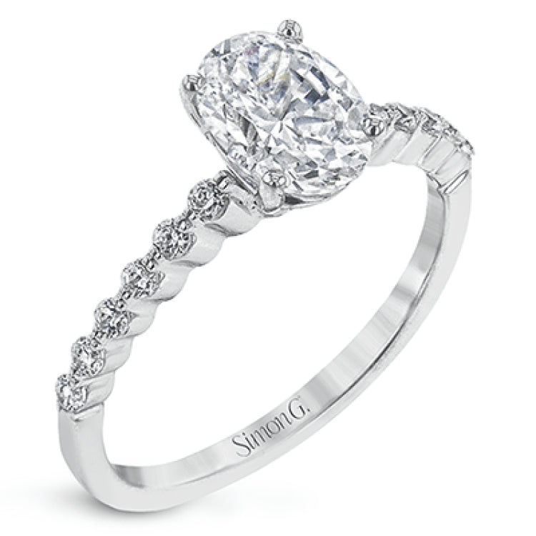 This contemporary wedding set features .48 ctw of diamond side stones and is designed to perfectly showcase an oval center stone.