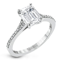 Simple yet stunning, this graceful engagement ring is made for an emerald cut center stone and is set with .16 ctw of white diamonds.