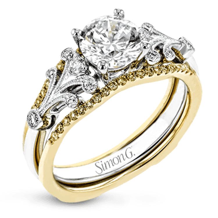 This two-tone gold wedding set features a white gold engagement ring that nestles perfectly into the yellow gold guard that is set with .20 ctw of yellow diamonds.