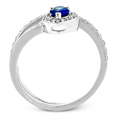 This spiraling 18k white gold ring features a .54 ct pear shaped blue sapphire accented by .33 ctw of white diamonds.