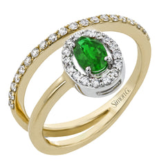 This exceptional ring crafted from 18k yellow gold is set with an oval shaped emerald and .33 ctw of white diamonds.
