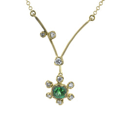 This charming 18k yellow gold pendant features and bright and cheery gemstone center, accented by .12 ctw of shining diamonds.