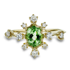 This 18k yellow gold fashion ring is set with .28 ctw of diamonds and a bright tsavorite garnet center stone.