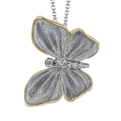 Symbolizing transformation, this butterfly pendent crafted in 18K white and yellow gold and accented by .06cttw diamonds is the perfect addition to any jewelry collection.