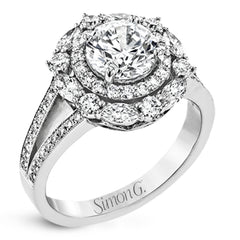 Rows of diamonds create a stunning effect in this 18k white gold engagement ring made for a round diamond. A total of .65 ctw of round diamonds and .35 ctw marquise diamonds surround the center stone.