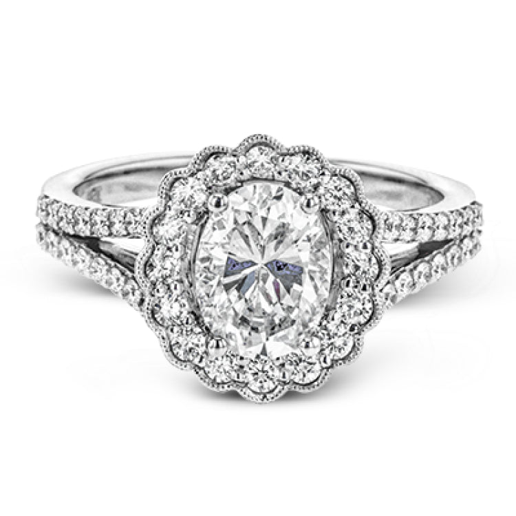 This delightful engagement ring features a scalloped halo that surrounds the center stone like a flower, containing .52 ctw of white diamonds.