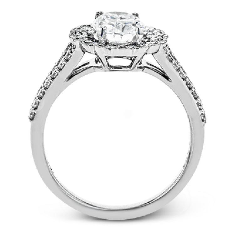 This delightful engagement ring features a scalloped halo that surrounds the center stone like a flower, containing .52 ctw of white diamonds.