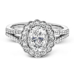 This delightful engagement ring features a scalloped halo that surrounds the center stone like a flower, containing .52 ctw of white diamonds.