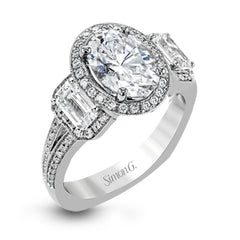 This impressive white gold ring features .43 ctw emerald cut side diamonds and is accented with .38 ctw round cut diamonds.