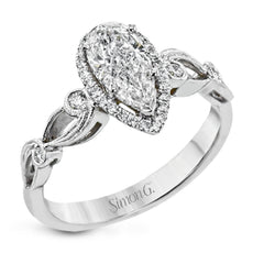 Reflecting a lovely romantic design, this white gold classic engagement ring features .16 ctw round cut white diamond accents.