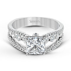 The lovely vintage style of this white gold engagement ring is further enhanced by .91 ctw of shimmering round cut diamonds.