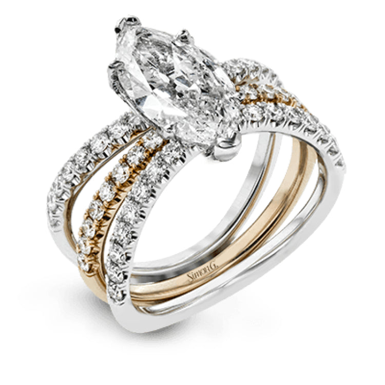 This distinctive bridal set design features a double-layer wedding band that fits around the engagement ring. The set contains .77 ctw of white diamonds.