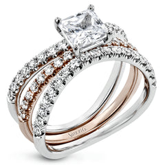 This distinctive bridal set design features a double-layer wedding band that fits around the engagement ring. The set contains .77 ctw of white diamonds.