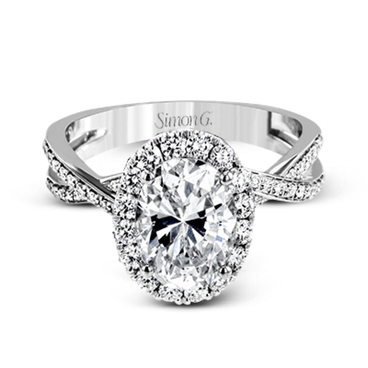 This sparkling modern engagement ring features an eye-catching twisted design with elegant classic halo accented by .29 ctw of shimmering round cut white diamonds.