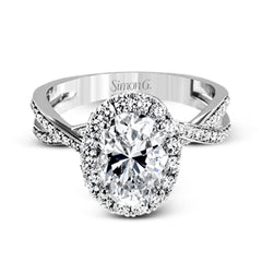 This sparkling modern engagement ring features an eye-catching twisted design with elegant classic halo accented by .29 ctw of shimmering round cut white diamonds.